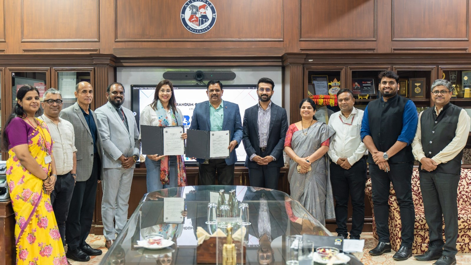 Alliance University staff signing the MoU with olympian Anju Bobby George to promote sports education.
