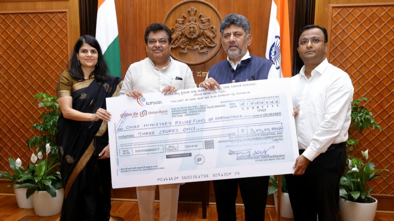 Separate visuals of the two cheques being handed over to Chief Minister DK Shivakumar.