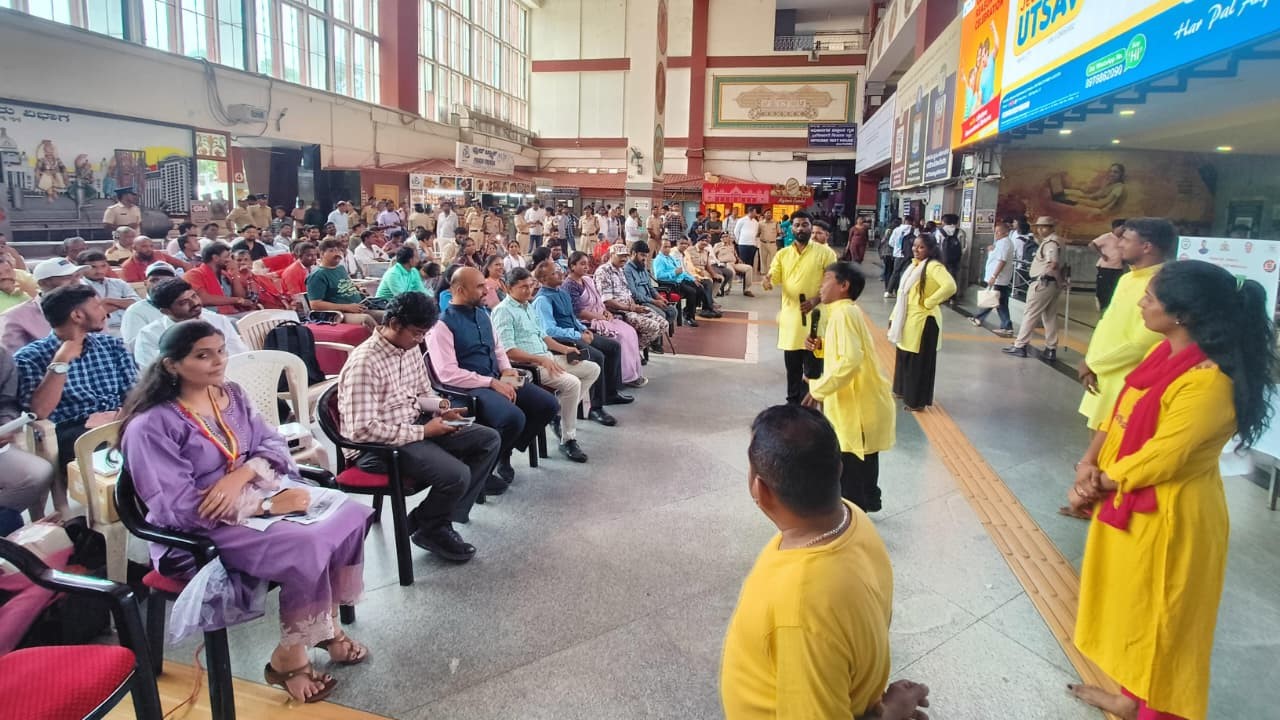 Officials and rail users during the awareness programme at KSR Bengaluru station.
