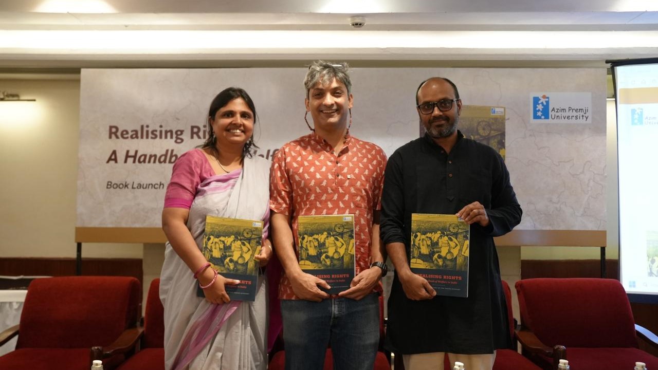 Faculty of Azim Premji University with the handbook.